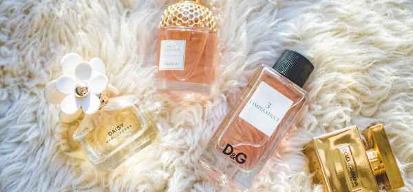 four assorted perfume glass bottles