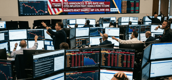 Traders at multiple computer monitors watching Federal Reserve rate hike announcement on large screen